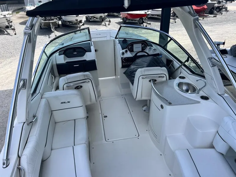 Slide: The Image of 2008 Sea Ray 270 SLX boat interior with white seating and modern dashboard. - 19