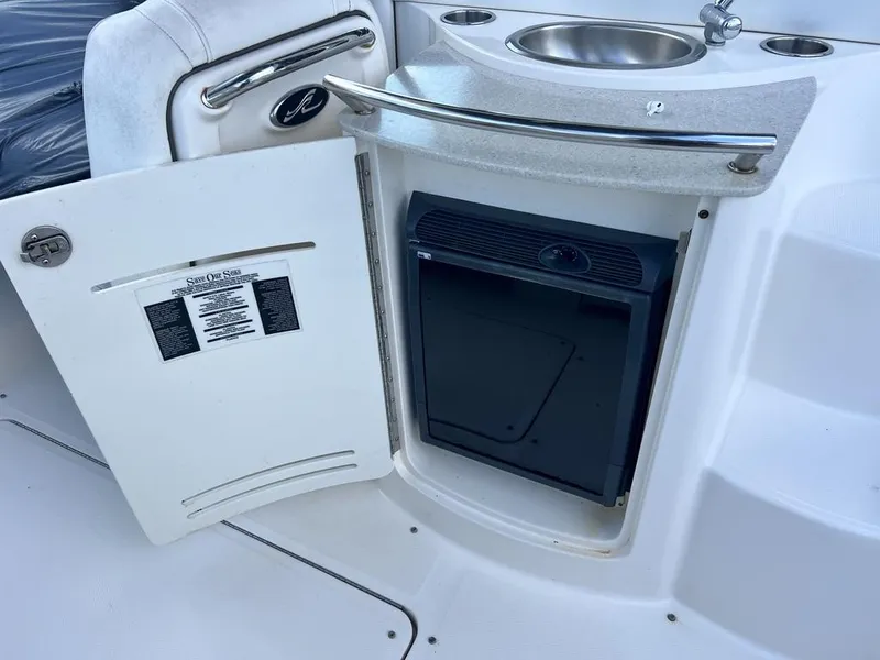 Slide: The Image of 2008 Sea Ray 270 SLX boat interior with mini fridge and sink. - 20