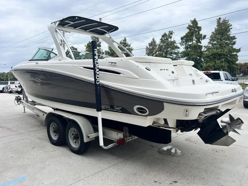 Slide: The Image of 2008 Sea Ray 270 SLX boat on trailer, parked outdoors. - 4