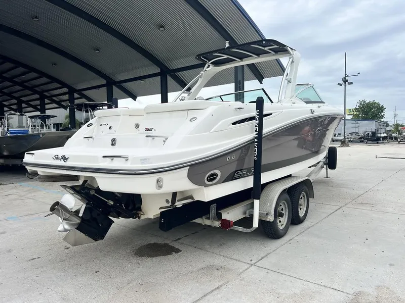Slide: The Image of 2008 Sea Ray 270 SLX boat on trailer in marina setting. - 6