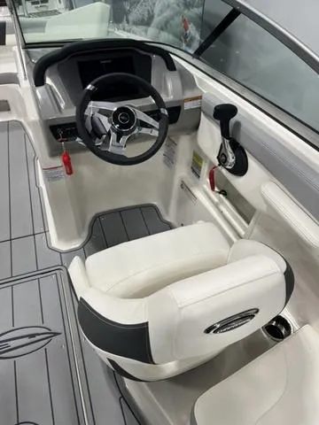 Slide: The Image of 2025 Chaparral 23 SSi boat interior with steering wheel and seating. - 10