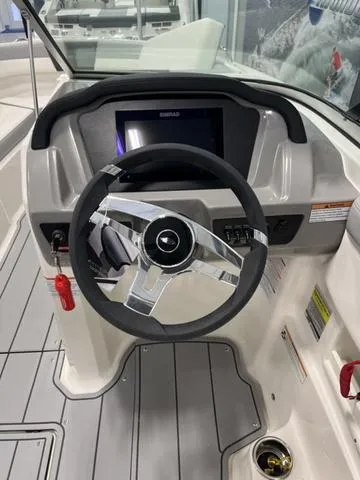 Slide: The Image of 2025 Chaparral 23 SSi boat dashboard with steering wheel and control panel. - 11