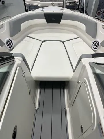 Slide: The Image of 2025 Chaparral 23 SSi boat interior with white and gray seating and flooring. - 12