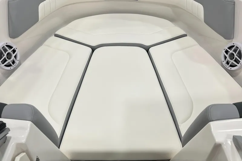 Slide: The Image of 2025 Chaparral 23 SSi boat interior with white cushioned seating and speakers. - 13