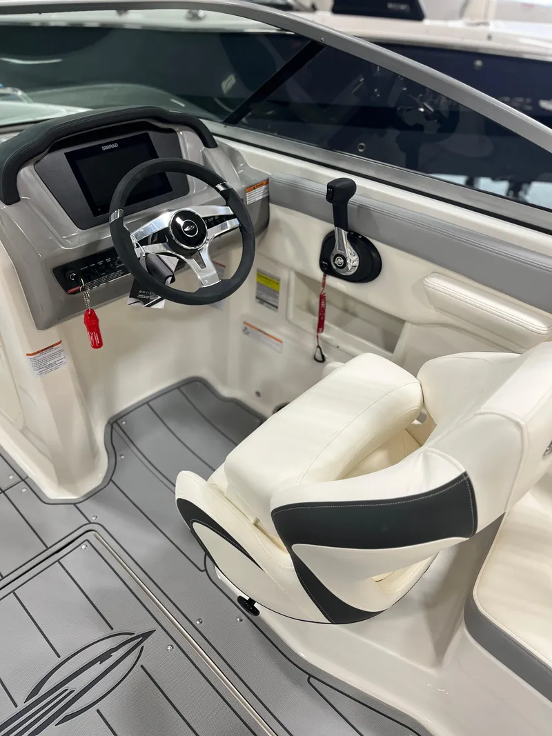 Slide: The Image of 2025 Chaparral 23 SSi boat interior with steering wheel and seating. - 14