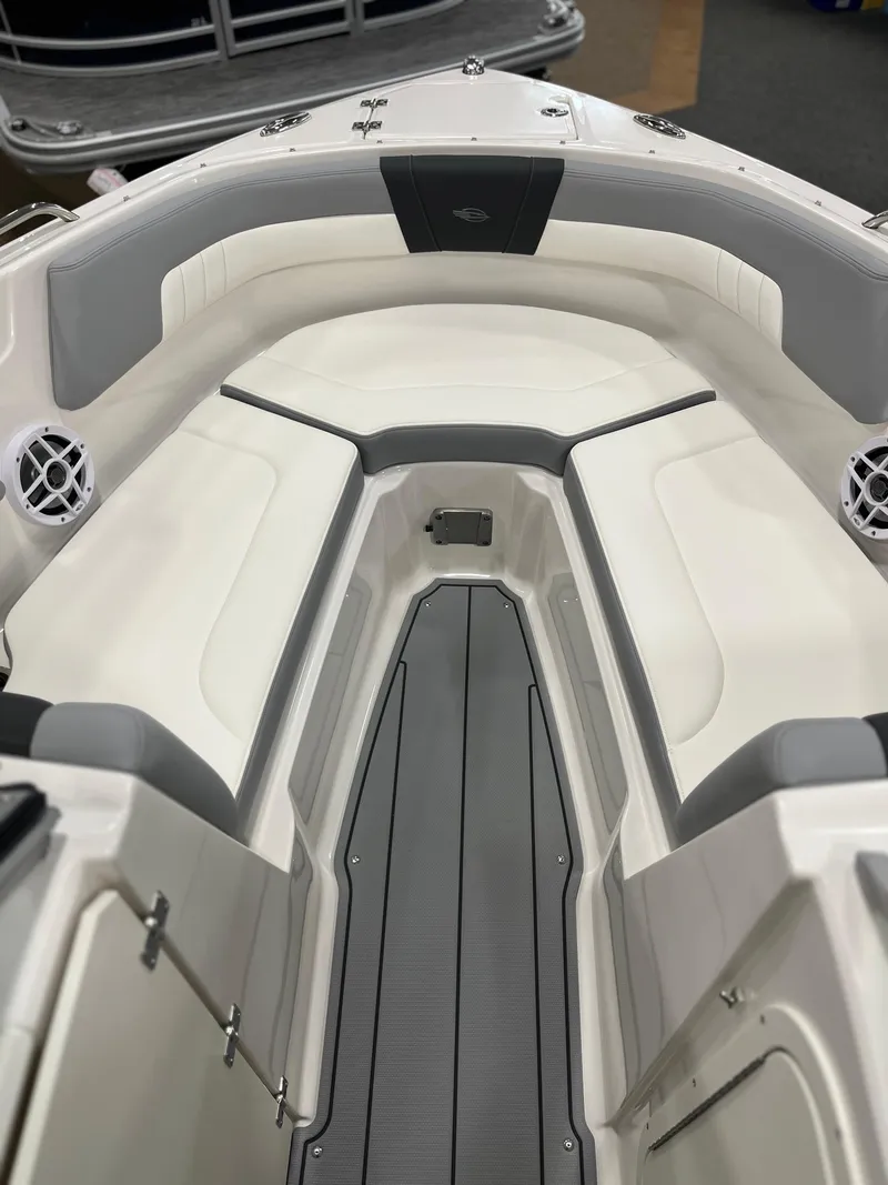 Slide: The Image of 2025 Chaparral 23 SSi boat interior with cushioned seating and sleek design. - 16
