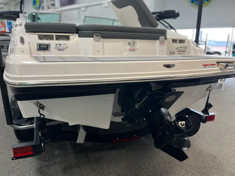 Slide: The Image of 2025 Chaparral 23 SSi boat rear view, showcasing propeller and sleek design. - 2