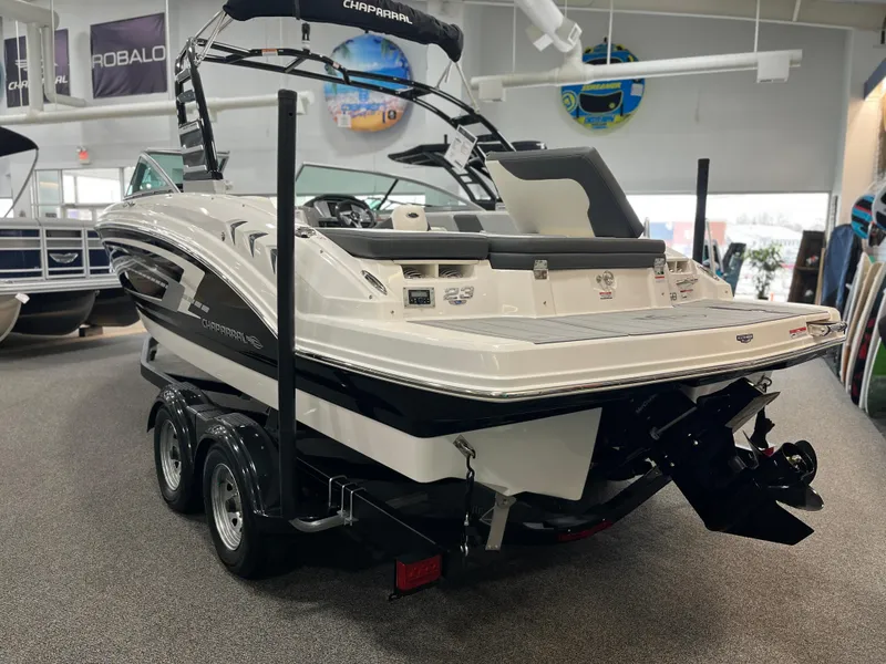 Slide: The Image of 2025 Chaparral 23 SSi boat on trailer in showroom, rear view. - 3