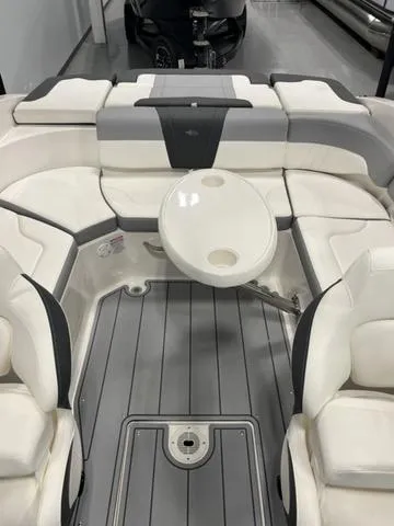 Slide: The Image of 2025 Chaparral 23 SSi boat interior with seating and table, gray and white design. - 8