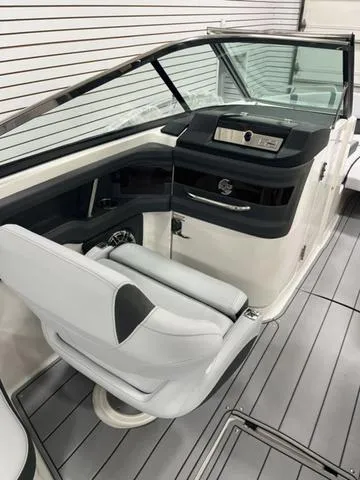 Slide: The Image of 2025 Chaparral 30 Surf boat in showroom, rear view with swim platform. - 8