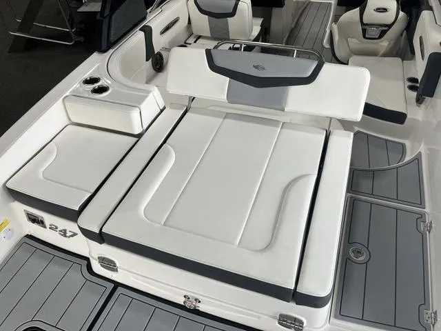 Slide: The Image of 2025 Chaparral 247 SSX boat interior with white seating and cup holders. - 3
