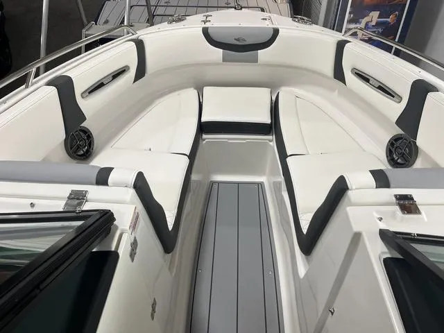 Slide: The Image of 2025 Chaparral 247 SSX boat interior with sleek white and gray seating. - 7