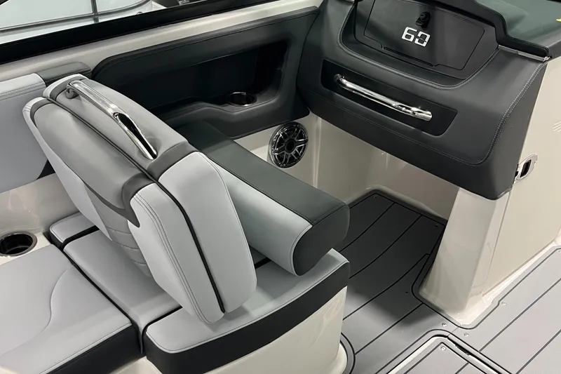 Slide: The Image of 2025 Chaparral 247 SSX boat interior with sleek seating and modern dashboard design. - 12
