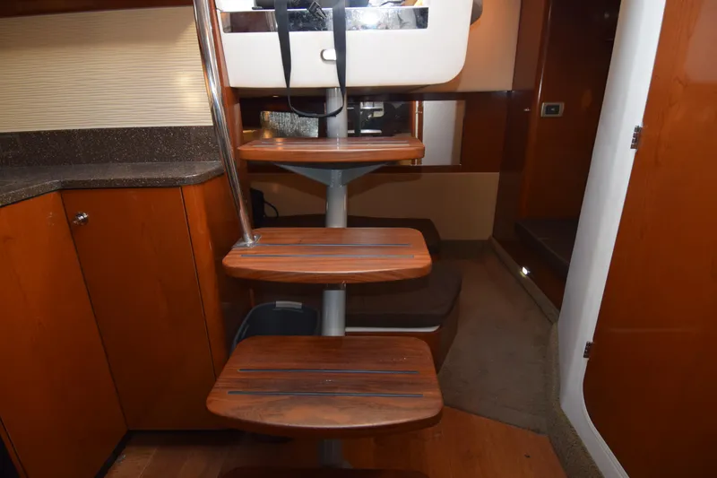 Slide: The Image of Interior stairs of 2014 Sea Ray 350 Sundancer yacht, featuring wooden steps and modern design. - 19