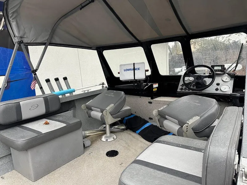 Slide: The Image of 2008 Duckworth Navigator Sport 195 boat interior with seating and navigation equipment. - 15