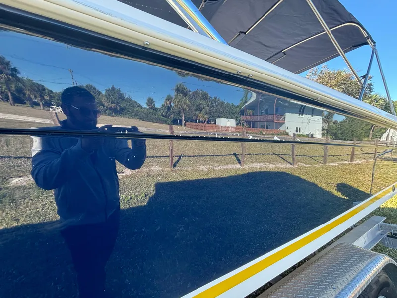 Slide: The Image of 2002 Marlago 35 FS boat with reflective blue hull and canopy. - 14