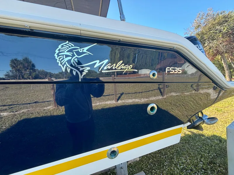 Slide: The Image of 2002 Marlago 35 FS boat with logo and model name on the side. - 15