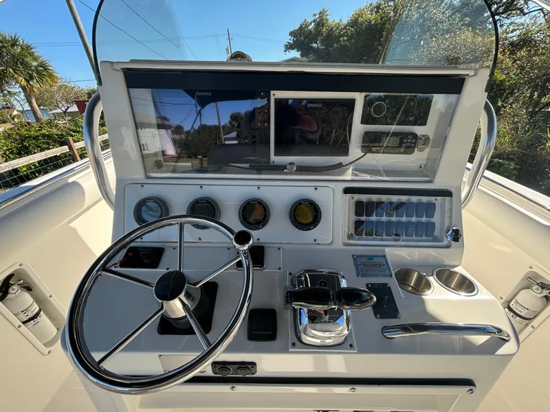 Slide: The Image of 2002 Marlago 35 FS boat dashboard with steering wheel and navigation controls. - 18