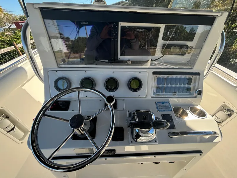 Slide: The Image of 2002 Marlago 35 FS boat dashboard with steering wheel and control panel. - 19