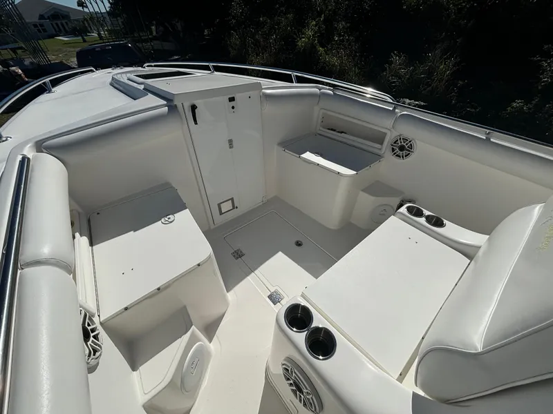 Slide: The Image of 2002 Marlago 35 FS boat interior with white seating and storage compartments. - 20