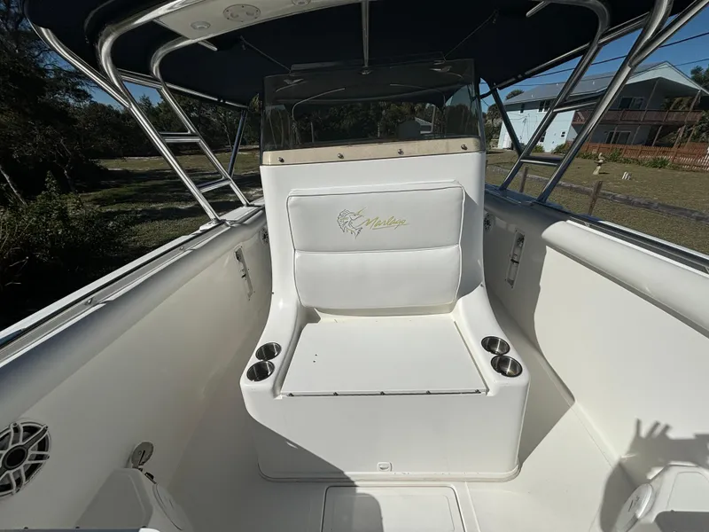 Slide: The Image of 2002 Marlago 35 FS boat interior with seating and cup holders. - 22