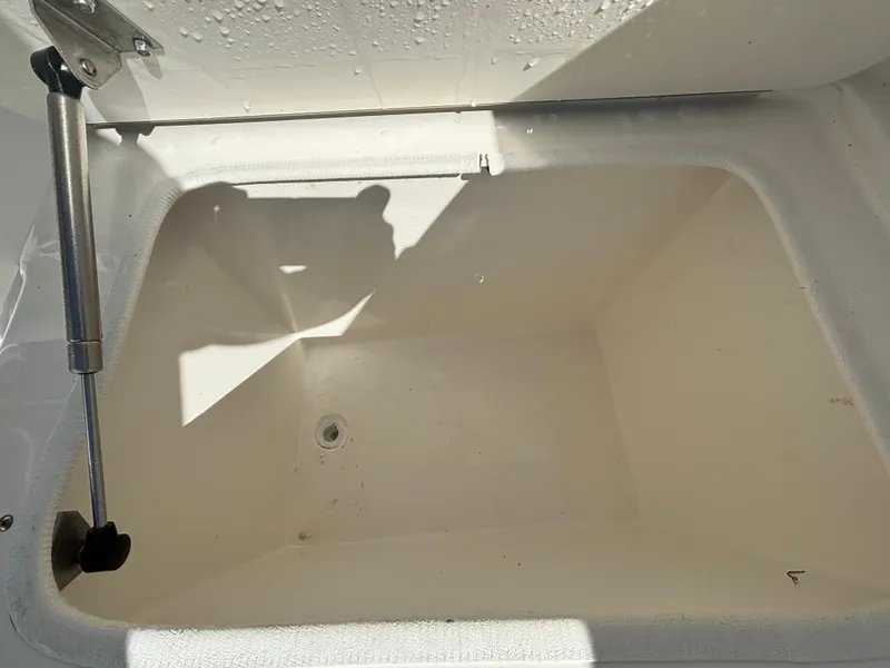 Slide: The Image of Open storage compartment in 2002 Marlago 35 FS boat, showing interior details. - 24