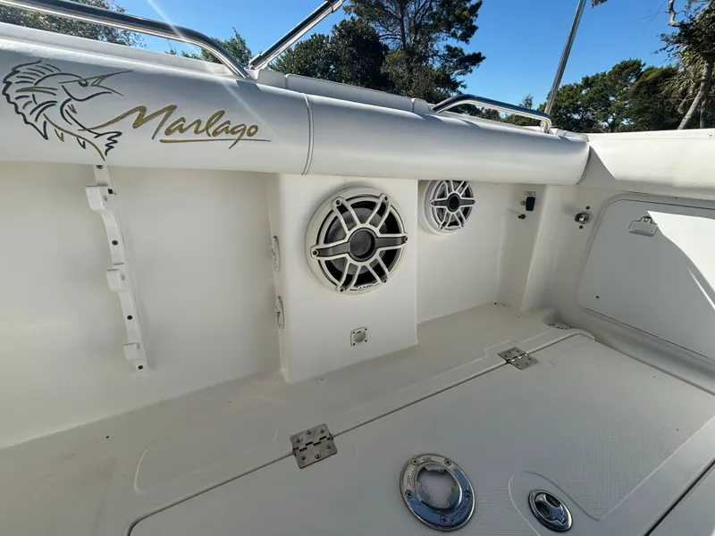 Slide: The Image of 2002 Marlago 35 FS boat interior with speakers and logo detail. - 28