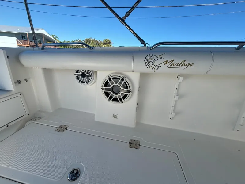 Slide: The Image of 2002 Marlago 35 FS boat interior with speakers and logo. - 29