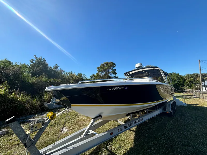 Slide: The Image of 2002 Marlago 35 FS boat on trailer under clear blue sky. - 3