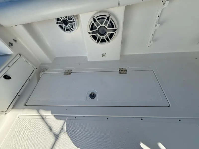 Slide: The Image of 2002 Marlago 35 FS boat interior with speakers and storage compartment. - 30