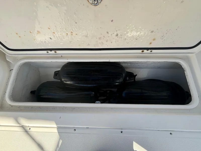 Slide: The Image of Storage compartment on a 2002 Marlago 35 FS boat with black fenders inside. - 31