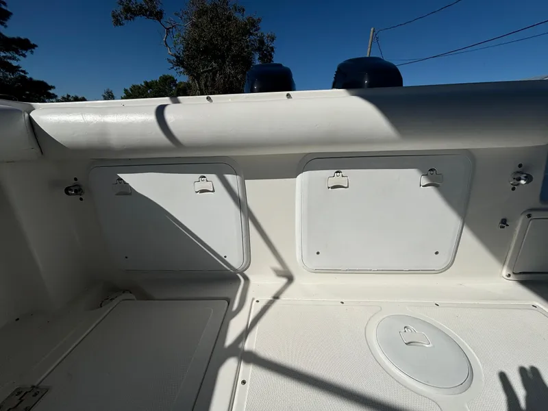 Slide: The Image of 2002 Marlago 35 FS boat interior with storage compartments and clean white deck. - 33
