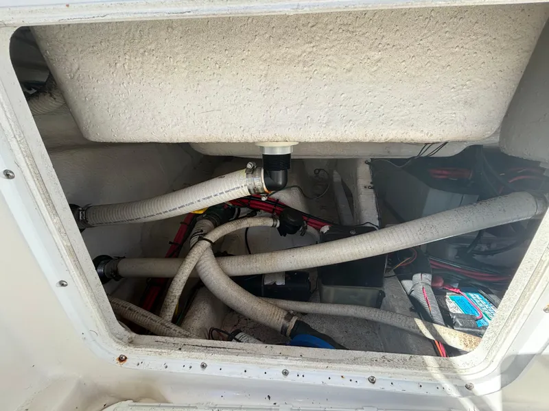 Slide: The Image of 2002 Marlago 35 FS boat interior showing plumbing and wiring components. - 34
