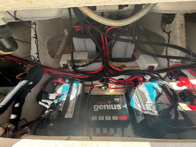 Slide: The Image of 2002 Marlago 35 FS boat battery compartment with wiring and charger. - 35