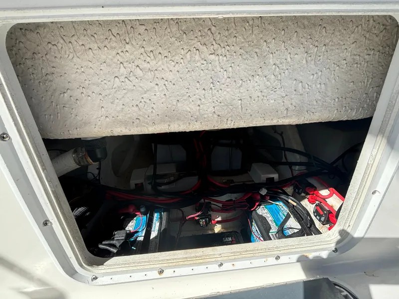 Slide: The Image of 2002 Marlago 35 FS boat battery compartment with wiring and connections. - 36