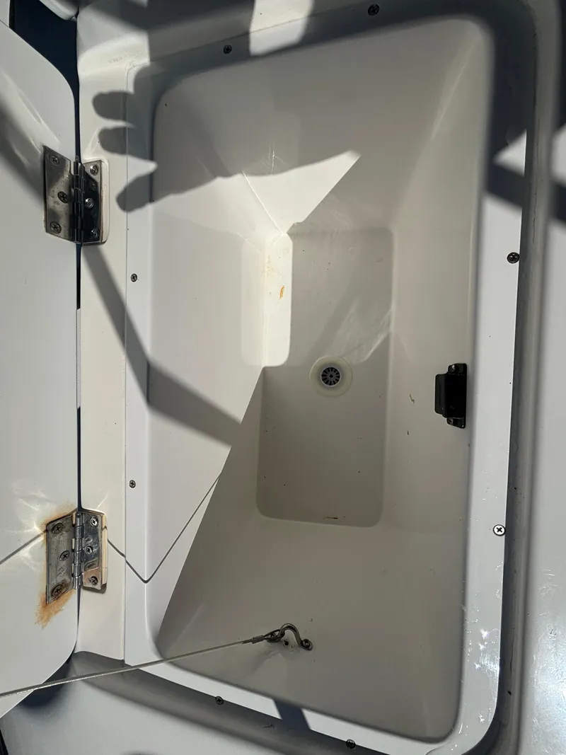 Slide: The Image of Open storage compartment on 2002 Marlago 35 FS boat, showing interior details. - 40
