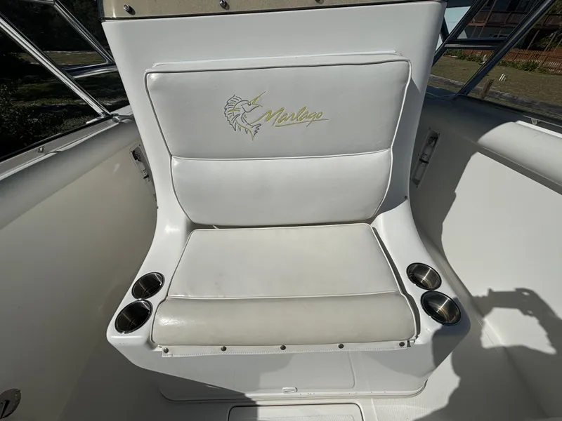 Slide: The Image of White seating on 2002 Marlago 35 FS boat with cup holders. - 46