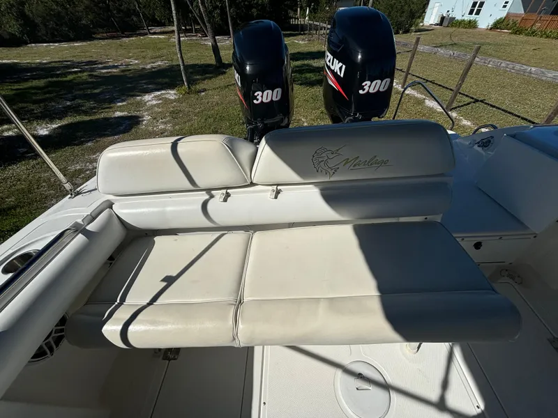 Slide: The Image of 2002 Marlago 35 FS boat with dual Suzuki 300 engines and cushioned seating. - 48