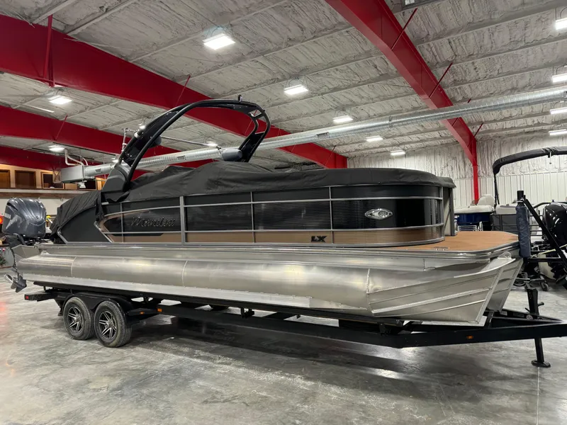 Slide: The Image of 2023 Manitou 25 LX Twin SHP pontoon boat in a showroom. - 14