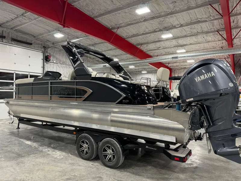 Slide: The Image of 2023 Manitou 25 LX Twin SHP pontoon boat with Yamaha engine in a showroom. - 4