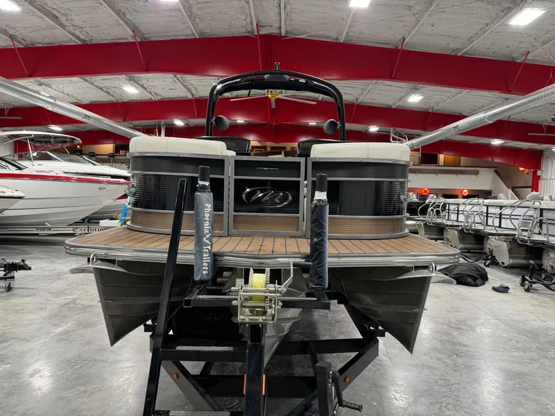 Slide: The Image of 2023 Manitou 25 LX Twin SHP pontoon boat in indoor showroom. - 5