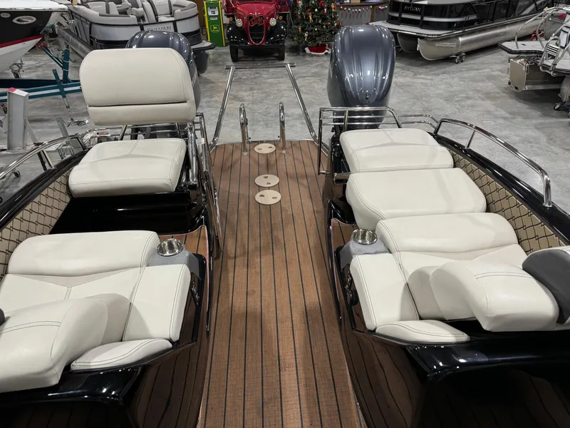 Slide: The Image of 2023 Manitou 25 LX Twin SHP boat with luxurious seating and wooden deck. - 9