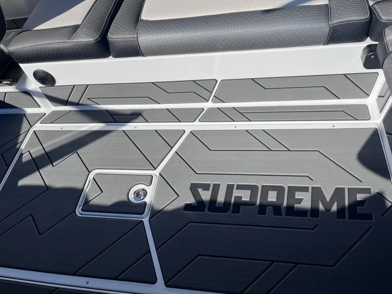 Slide: The Image of 2025 Supreme S240 boat deck with stylish gray pattern and logo. - 11