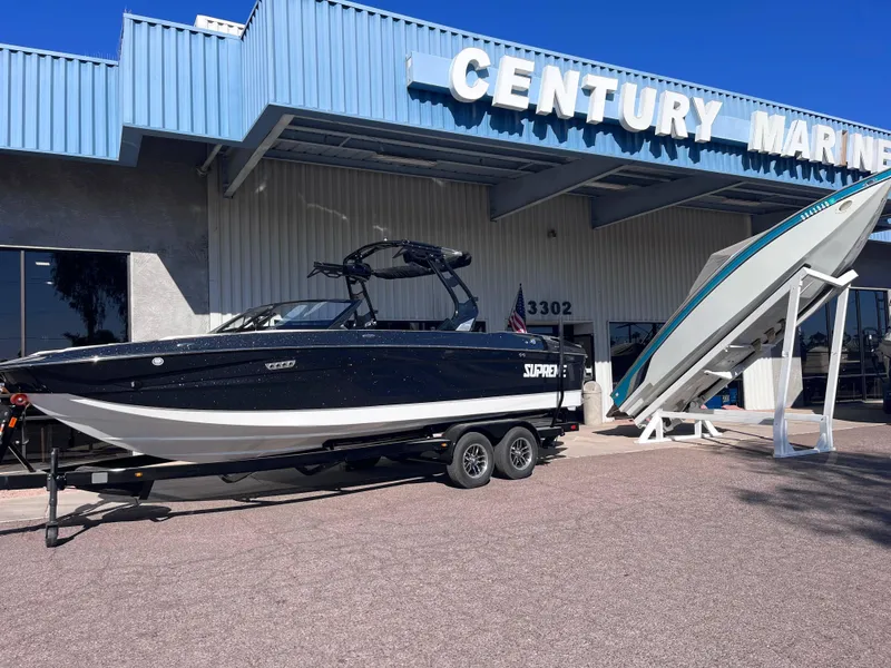 Slide: The Image of 2025 Supreme S240 boat displayed at Century Marine dealership. - 2