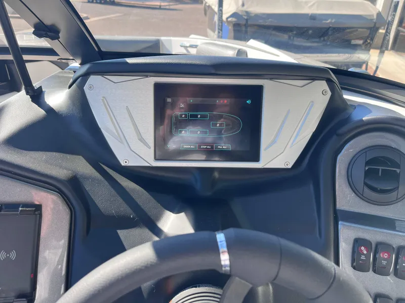 Slide: The Image of 2025 Supreme S240 boat dashboard with touchscreen display and controls. - 7