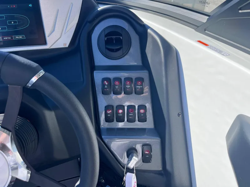Slide: The Image of Dashboard controls of 2025 Supreme S240 boat with steering wheel and switches. - 9