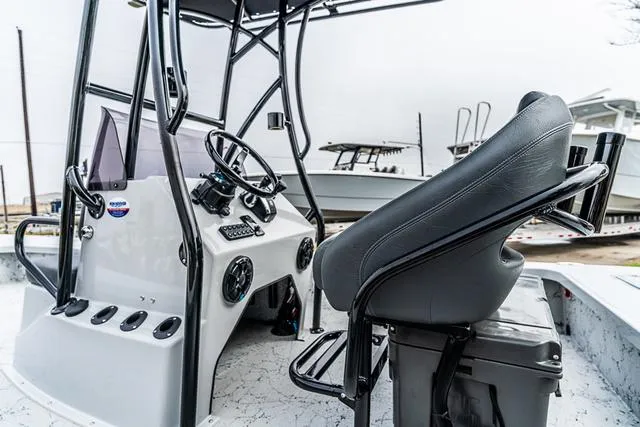 Slide: The Image of 2024 Majek Boats 25 XTREME interior with steering console and seating. - 2