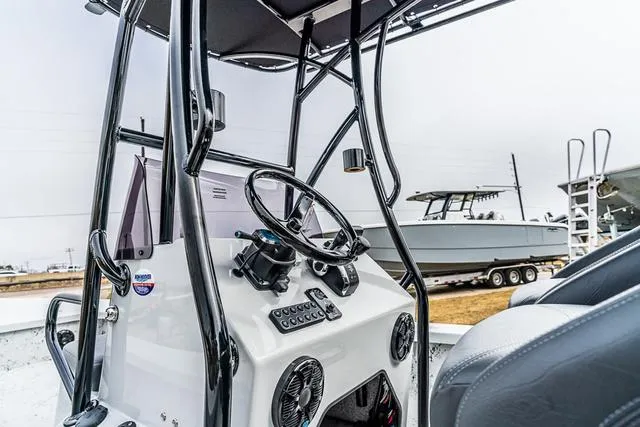 Slide: The Image of 2024 Majek Boats 25 XTREME console with steering wheel and controls, showcasing modern design. - 4