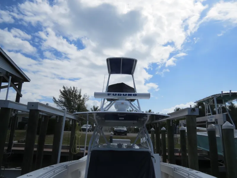 Slide: The Image of 2015 Invincible 42 Open Fisherman boat docked under a partly cloudy sky. - 17