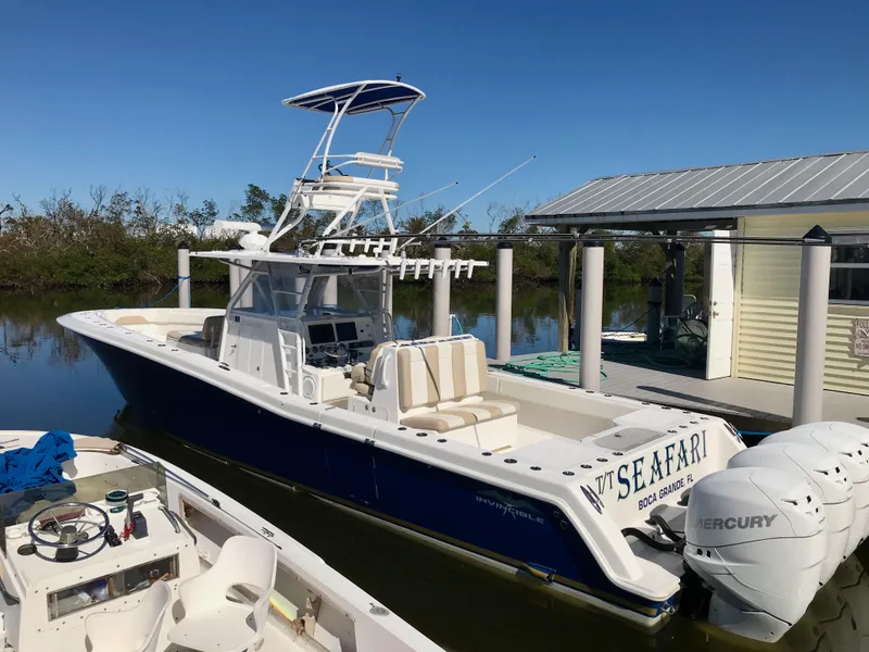 Slide: The Image of 2015 Invincible 42 Open Fisherman boat docked with triple Mercury engines. - 2